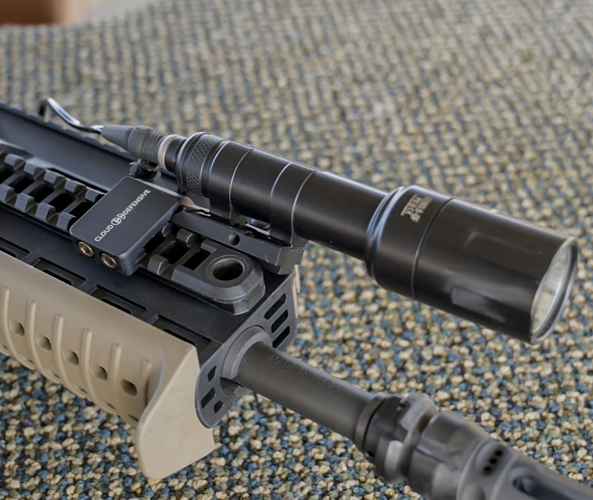 Side view of black Torrent picatinny mount installed on a handguard with Rein flashlight.