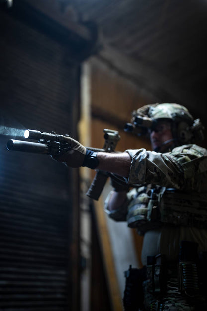 Military member with rifle and Rein flashlight