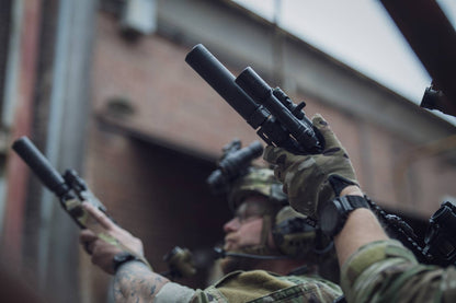 Military members with rifles and black Rein flashlights