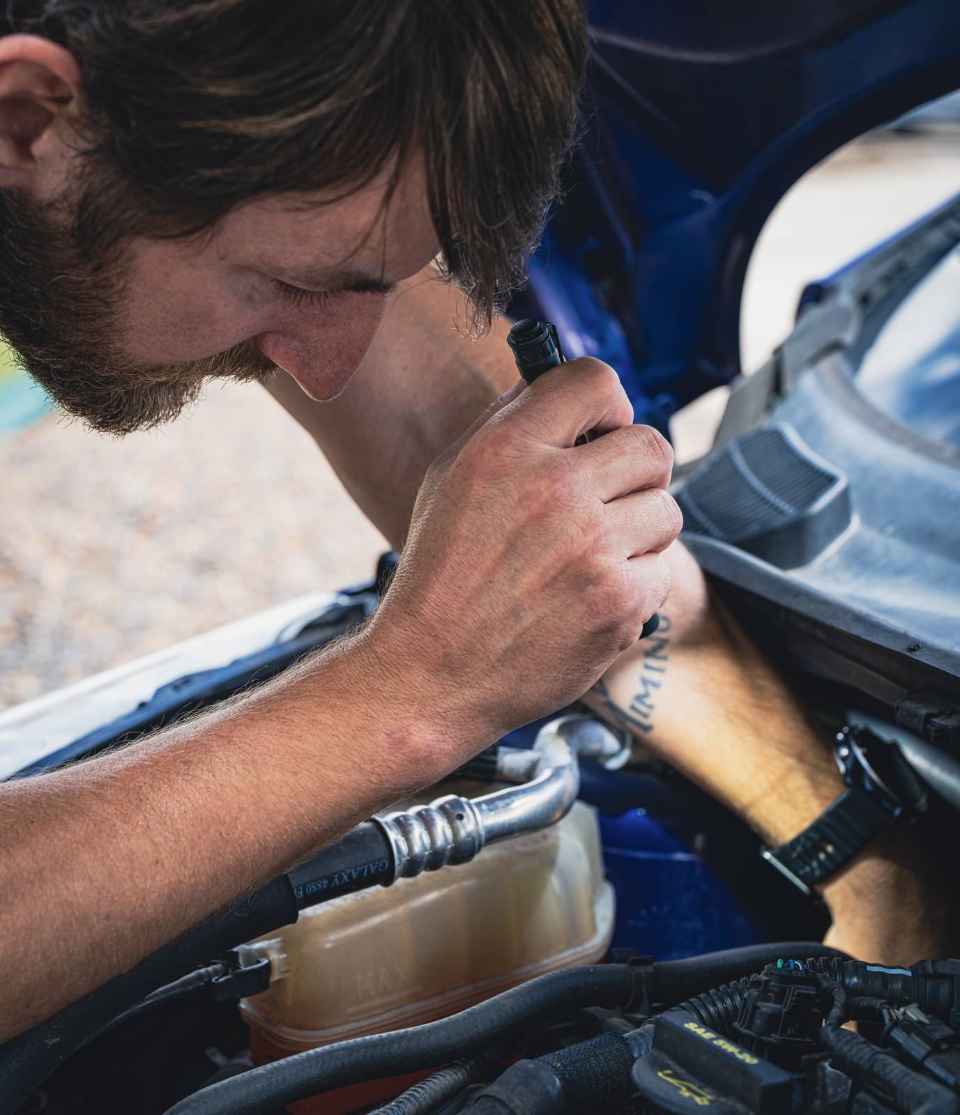 Man inspecting engine with a Chicro XL light.