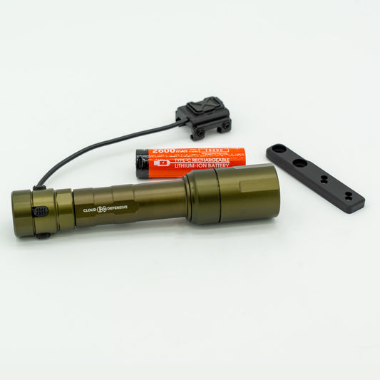 A green flashlight with battery and accessories on a white background