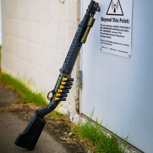 A shotgun with a green Rein on it 